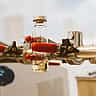 Glass vials held by red-handled metal clamps in a pharmaceutical research laboratory.