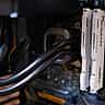 White computer RAM sticks installed alongside a cooling system inside a desktop PC.