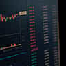 A computer screen displays vibrant financial market data and charts.