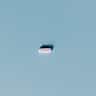 A single white pill centered on a minimalist light blue background.