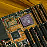 A close-up view of a vintage Advanced Micro Devices AM486 DX processor installed on a computer motherboard.