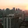 A vibrant sunset over the modern skyscraper skyline of Taguig City, home to the Philippine Stock Exchange.