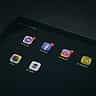 A tablet screen displays app icons for Meta properties including Facebook, Instagram, and Messenger.