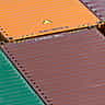 A dense grid of vibrantly colored shipping containers stacked together.