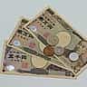 A collection of Japanese yen banknotes and coins arranged on a flat surface.