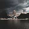 The US Capitol Building stands under dark, stormy clouds in Washington, D.C.