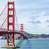 A clear daytime view of the red towers and suspension cables of the Golden Gate Bridge spanning San Francisco Bay.
