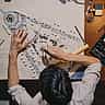 An overhead view of an architect using a compass and ruler to measure a detailed site blueprint.