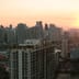 A vibrant sunset over the modern skyscraper skyline of Taguig City, home to the Philippine Stock Exchange.