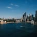 The Sydney skyline on a clear day, featuring the Opera House alongside the modern high-rises of the central business district.