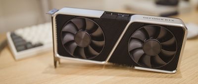 A close-up of a modern Nvidia GeForce RTX graphics card resting on a wooden desk.