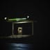 An isolated gas station glows brightly against a dark night sky.