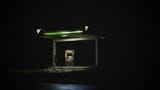 An isolated gas station glows brightly against a dark night sky.