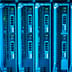 Rows of computer server racks illuminated with bright blue LED lights in a data center.