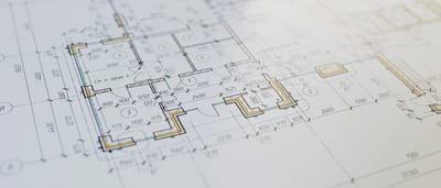 A close-up of a detailed architectural floor plan resting on a flat surface.