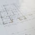 A close-up of a detailed architectural floor plan resting on a flat surface.