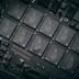 A detailed macro view of modern semiconductor chips and electronic components mounted on a sleek, dark circuit board.