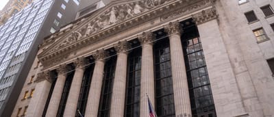 The neoclassical stone facade and columns of the New York Stock Exchange building on Wall Street.