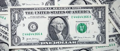 A close-up view of a stack of United States dollar bills.