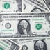 A close-up view of a stack of United States dollar bills.