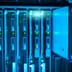 A close-up view of a glowing blue server rack component being adjusted in a modern data center.