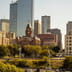 The Dallas skyline featuring modern corporate skyscrapers rising behind historic red brick architecture.