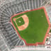 A top-down aerial view of an empty major league baseball stadium and its green diamond.